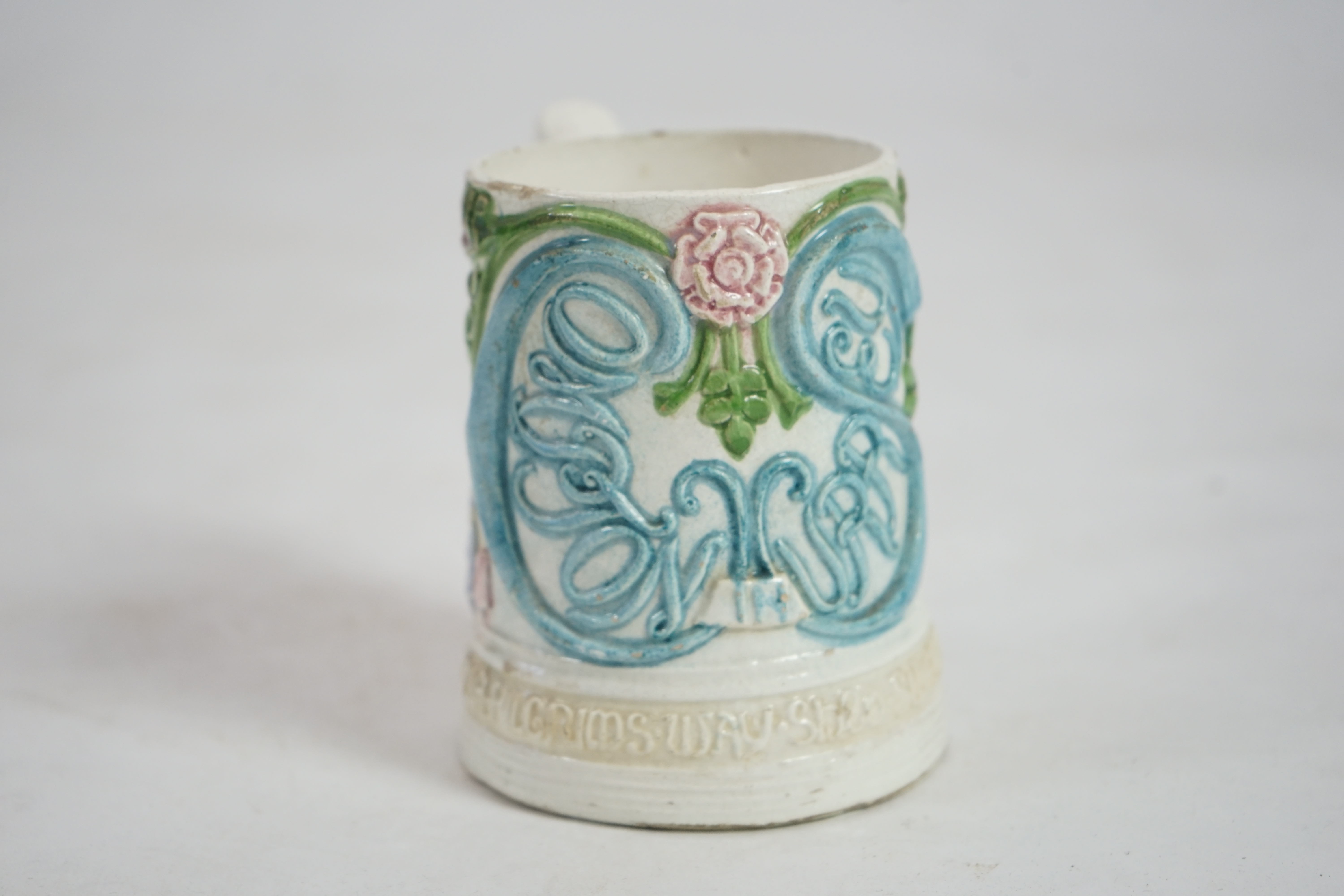 A Compton pottery mug, decorated with St Nicholas on a pilgrimage, 12cm high. Condition - poor